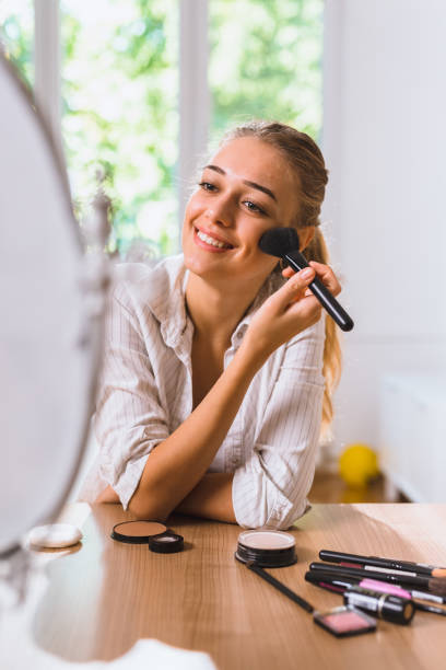 istock woman makeup at home 1057113474