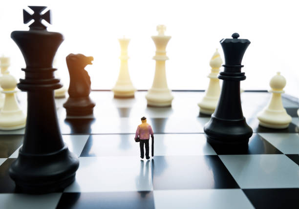 istock Old woman figurine standing on a chessboard 1057116166