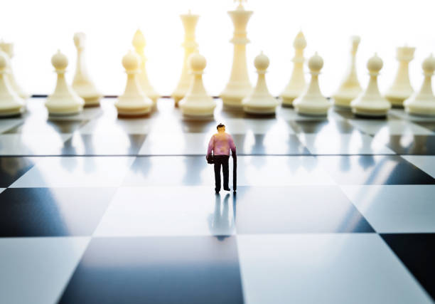 istock Old woman figurine standing on a chessboard 1057116200