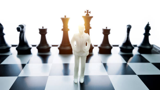 istock Man figurine standing on a chessboard 1057116240