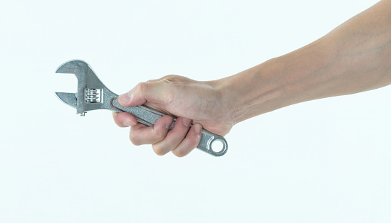 Man hand holding a wrench on white background.