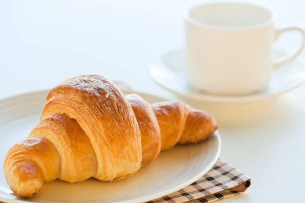 istock croissant and coffee 1057118226