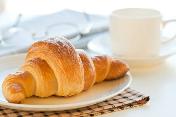 istock croissant and coffee 1057118482