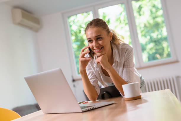 istock woman using laptop at her home 1057118854
