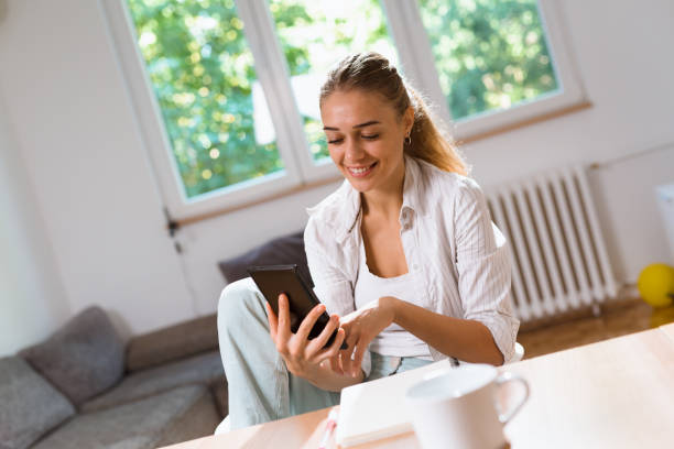 istock woman using tablet and enjoying coffee at her home 1057118922
