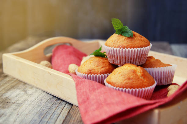 istock Homemade muffin on orange napkin, on the rustic background. Selective focus. 1057126010