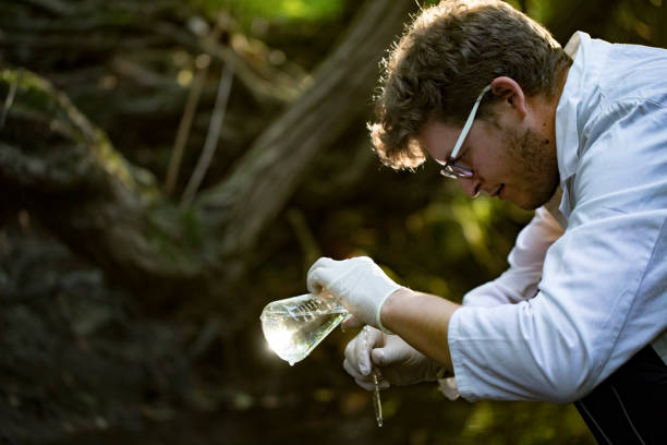 istock Young Researcher Examining Water in a Stream 1057132320