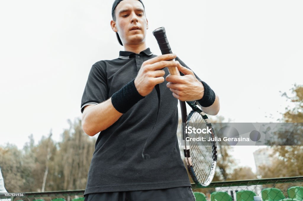 Putting New Grip Tape On Racket Wrapping Finishing On Racquet Stock Photo - Download Image Now - iStock