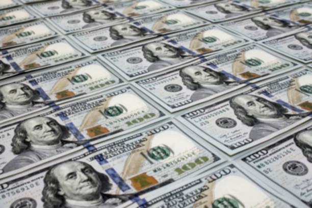 istock Scattered one hundred dollas banknotes close up background 1057136536