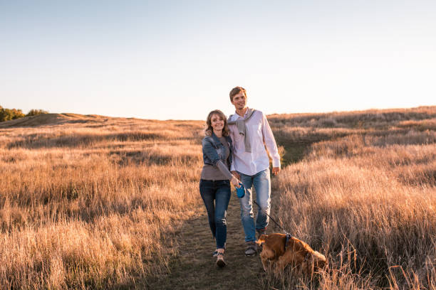 istock Happy young couple is walking with dog. 1057141480