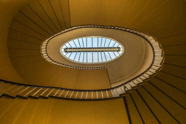 An elliptic staircase winding down an old building - 2