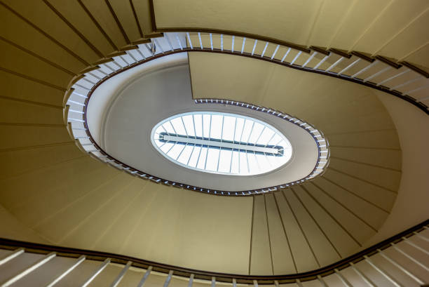 An elliptic staircase winding down an old building - 1