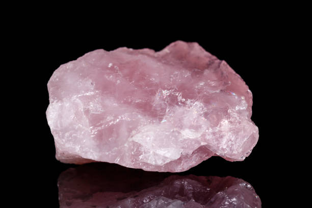 istock Macro mineral stone Pink quartz on black background 1057144030