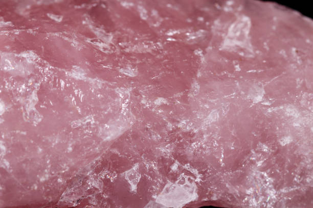 istock Macro mineral stone Pink quartz on black background 1057144162
