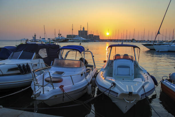 istock Boats at sunrise at Mandraki harbor 1057149330