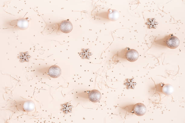 istock Christmas composition. Christmas golden decorations on pastel beige background. Flat lay, top view 1057149496