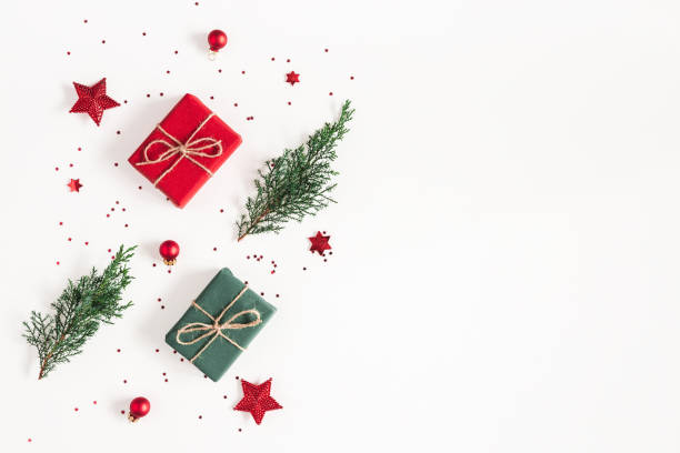 istock Christmas composition. Gifts, fir tree branches, red decorations on white background. Christmas, winter, new year concept. Flat lay, top view, copy space 1057151108