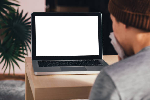 istock Young Asian male patient with sickness using an empty copy space notebook screen on bed at home - Telecommunication Healthcare concept 1057154864