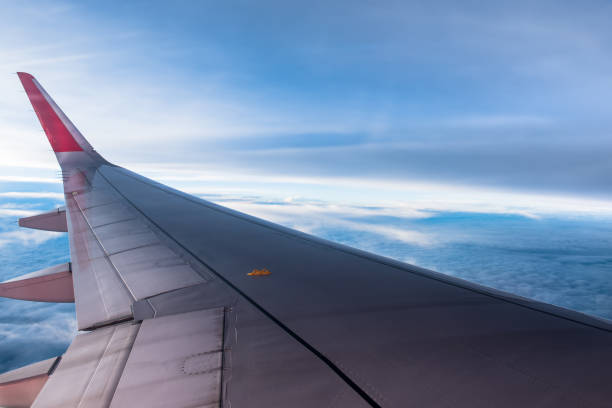 istock Sunrise with in twilight time with wing of an airplane. 1057155204