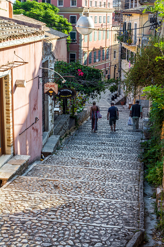 Corfu island, Greece - August 25, 2018: Narrow tourist street with people walking at Corfu city, Greece.