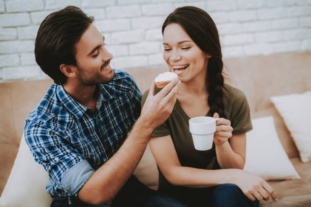 istock Happy Man Feeding Sandwich Smiling Woman with Cup 1057157004