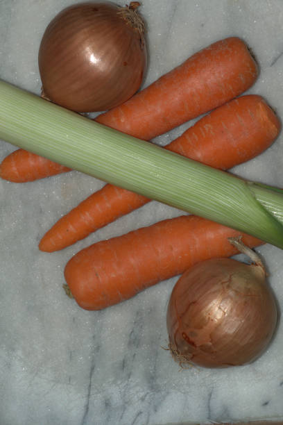 Carrot, onion and leek on a chopping board