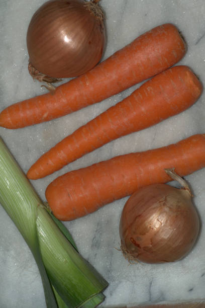 Carrot, onion and leek on a chopping board