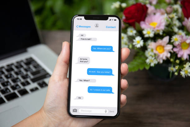 istock female hand holding phone with app messenger on the screen 1057168560
