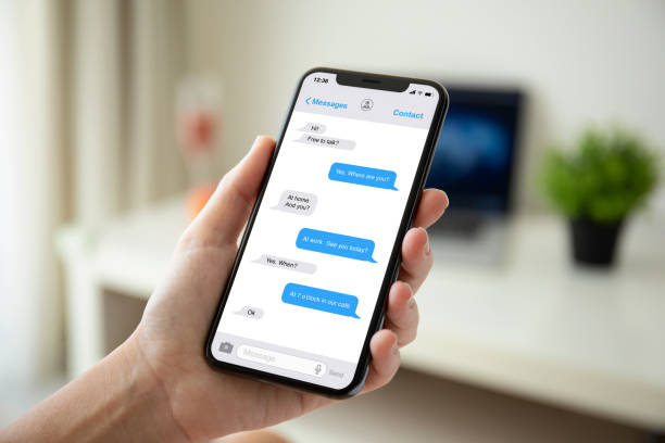 istock woman hand holding phone with app messenger on the screen 1057168564