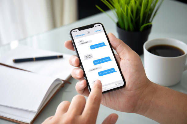 istock man hands holding phone with app messenger on the screen 1057168568
