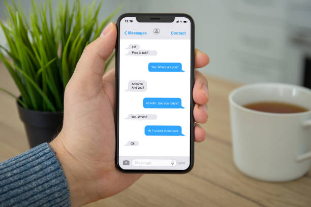 istock Male hand holding phone with app messenger on the screen 1057168570