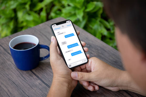 istock Male hands holding phone with app messenger on the screen 1057168572