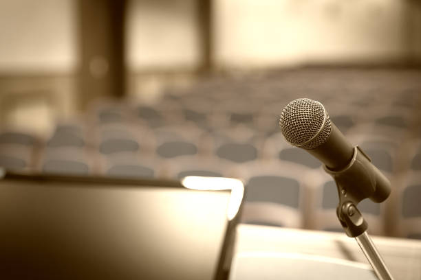 istock Rostrum with microphone and computer in conference room 1057171424