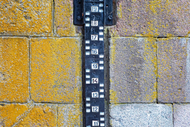 Water level measurement attach to the stone wall near the river
