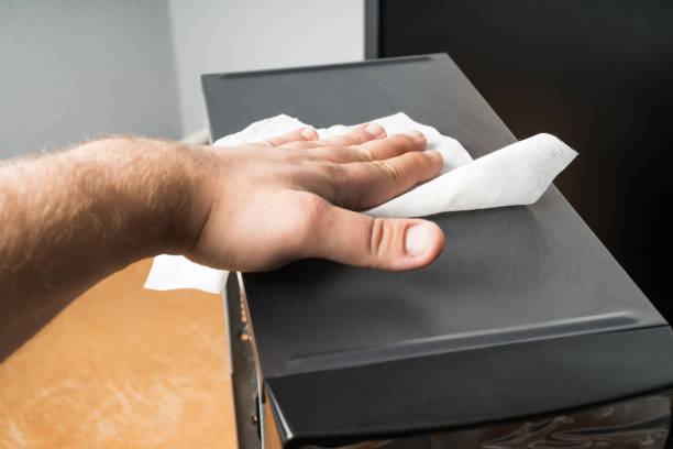 istock Caucasian man cleaning dust out of a pc computer. 1057173604