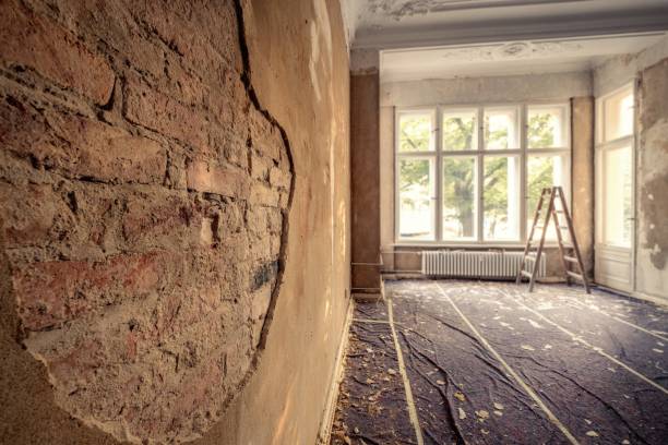 istock renovation concept  - plastering wall in old apartment room  restoration 1057173620