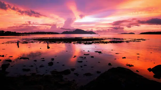 Beautiful light dramatic sky scenery over tropical sea with reflexion in the water,beautiful sunrise at phuket thailand