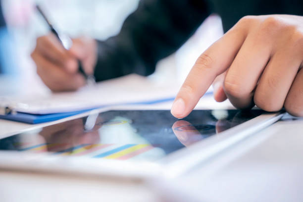 istock male hand touching on digital tablet while working at office. 1057176774