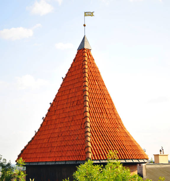 Weathercock on top of house roof