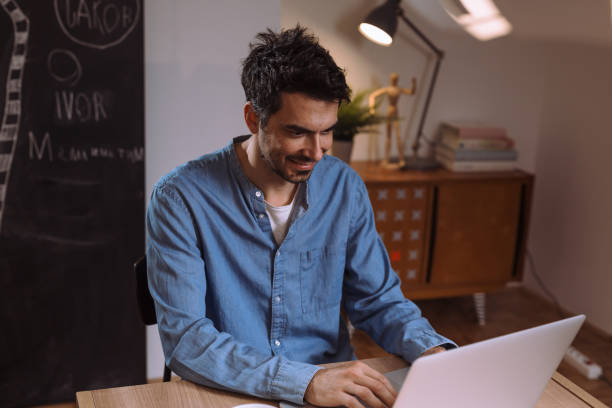 istock man working late night at his home 1057189650