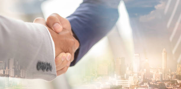 Business handshake with background double exprosure merger concept.