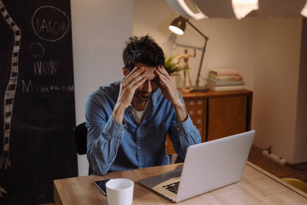 istock man working late night at his home 1057189936