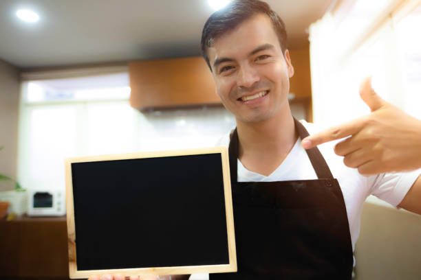 istock Cooking man or chef point to blank copy space that can add some text or some content about food or detail of something. 1057190162
