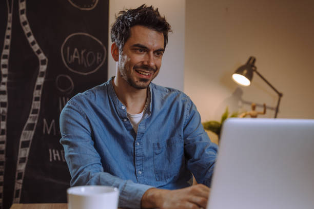 istock man working from his home. late night 1057192056