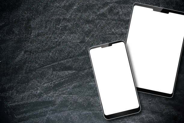 istock Blank digital tablet PC and smart phone on the blackboard background 1057194652