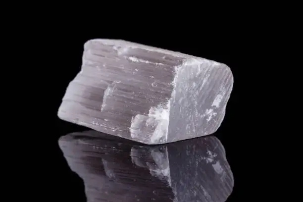 Macro mineral stone Selenite on black background close up