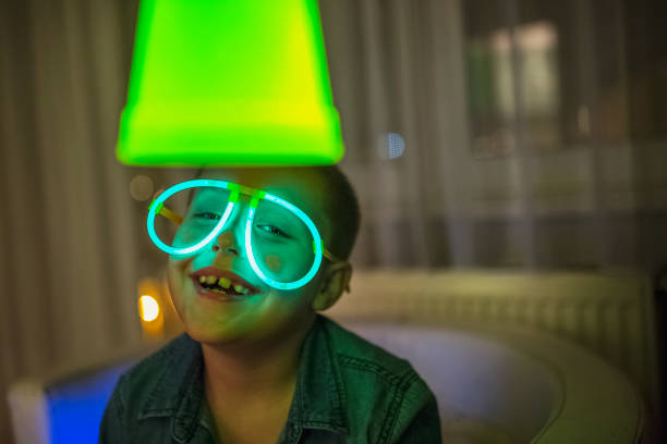 Boy wearing neon eyeglasses and having fun