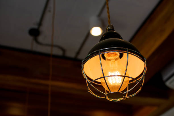 istock An orange light bulb caught on a beautiful ceiling. 1057209828