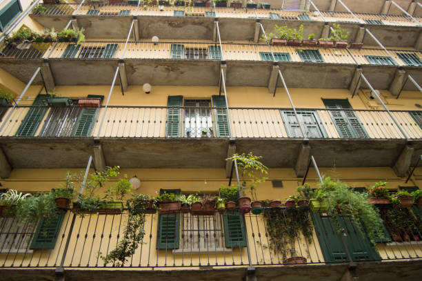 Traditional Italian homes with shutter window, balconies, flowers, Milan, October 2018, bottom view stock photo
