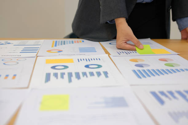 istock Businessman holding sticky note on business document. paper reminder schedule for creativity idea 1057213816